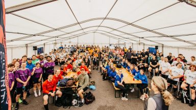 Teams from the 2025 Broadcast Fives sat in a marquee during a briefing session for the day.